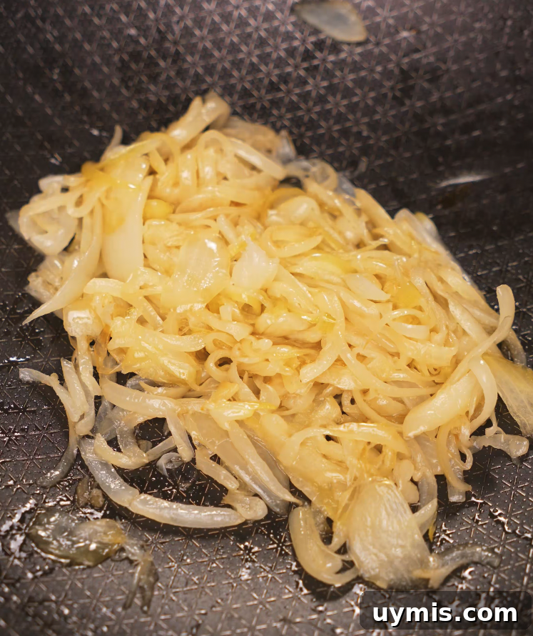 Spicy Chili Oil Pasta with Caramelized Onions 5 Thinly sliced onions caramelizing in oil in a nonstick pan for the base of the chili oil pasta.