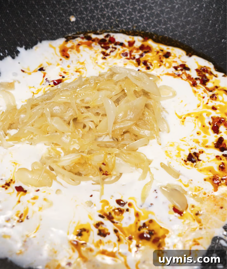 Spicy Chili Oil Pasta with Caramelized Onions 6 Caramelized onions added to a creamy chili oil sauce in a pan to build the flavor base.