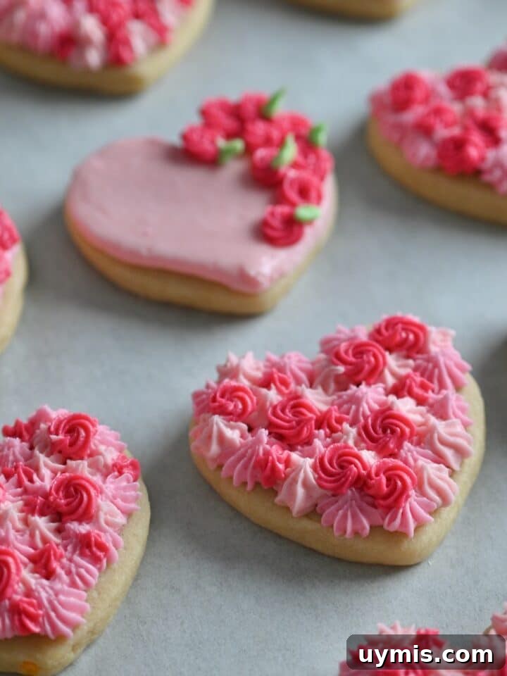 Soft Valentine heart cookies with thick buttercream frosting piped in shades of pint.