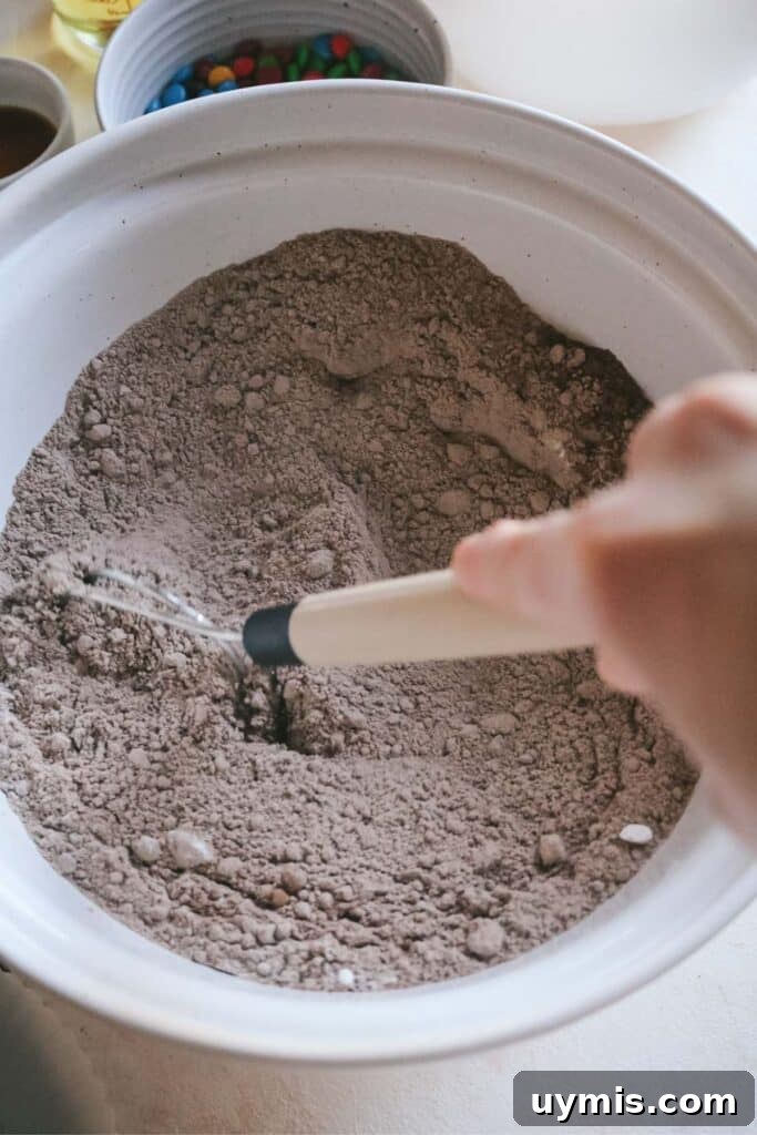 Thick and Chewy M&M Brownies Recipe 14 whisking brownie mixes, instant clearjel, and dry ingredients in a large mixing bowl.