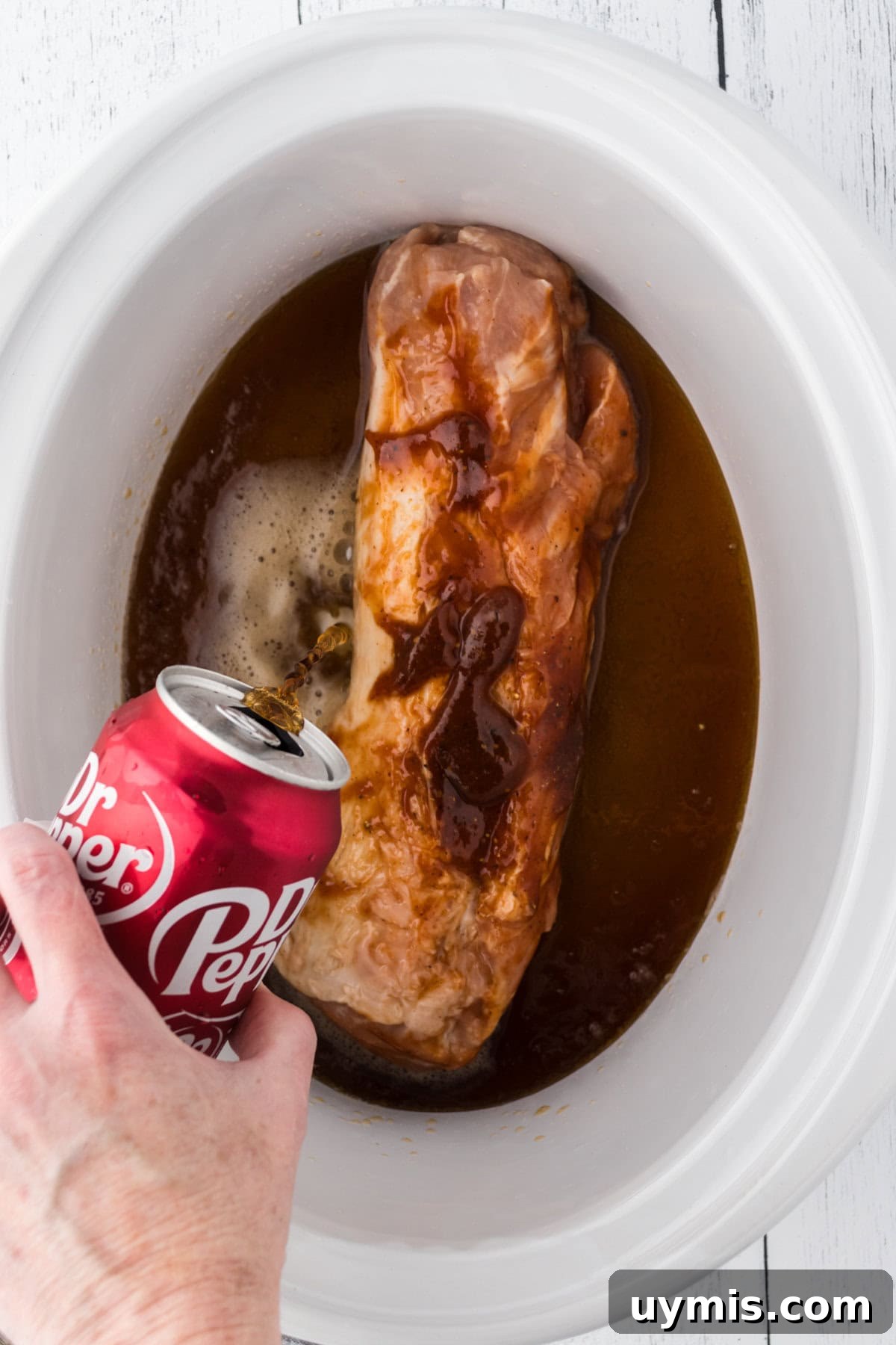 Slow-Cooker Dr Pepper Pulled Pork Recipe 6 Pouring the can of Dr Pepper into the slow cooker.
