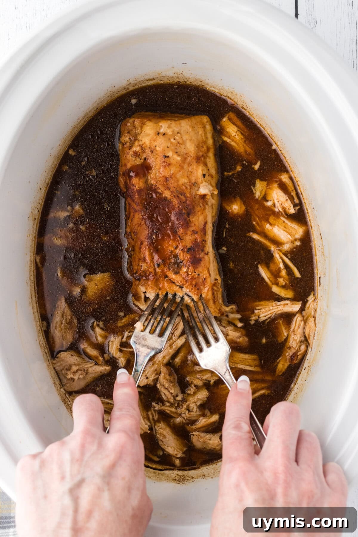 Slow-Cooker Dr Pepper Pulled Pork Recipe 7 Shredding the Dr Pepper pulled pork in the slow cooker.