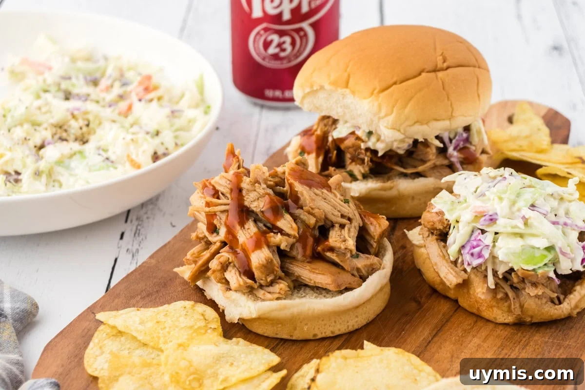 Slow-Cooker Dr Pepper Pulled Pork Recipe 9 Dr Pepper pulled pork on a sandwich bun with coleslaw.