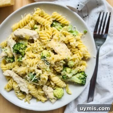 Light Chicken and Broccoli Pasta Recipe 13 A plate of chicken and broccoli pasta with grated parmesan cheese on top.