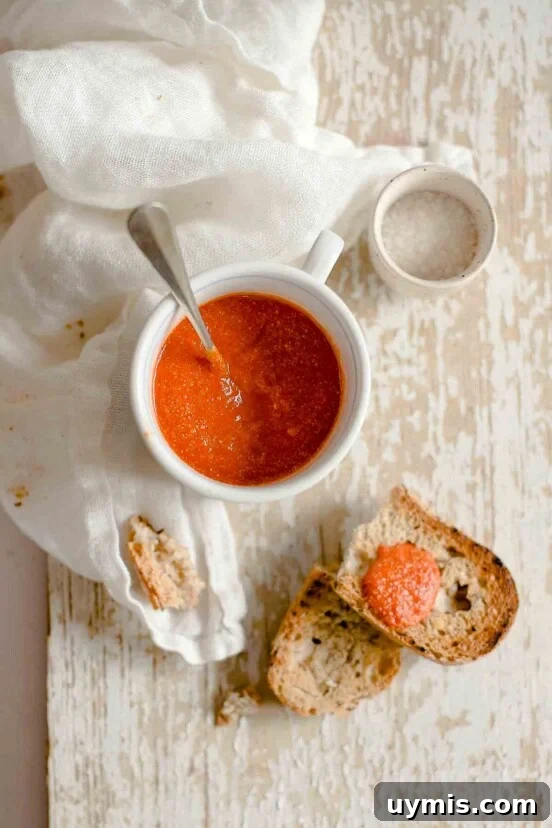 Sugo di Pomodoro Italian Tomato Sauce Recipe 8 A white bowl of romesco sauce with a slice of bread nearby.