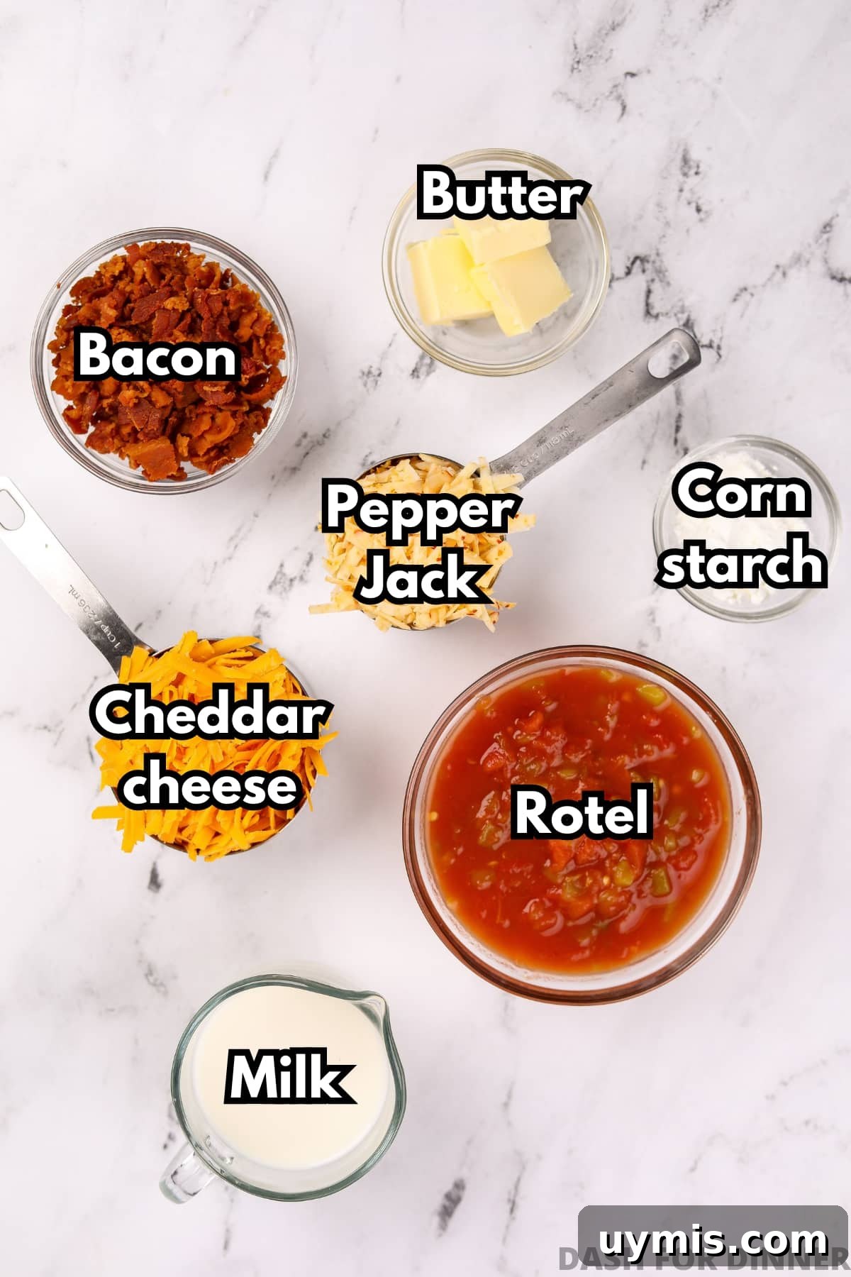 Homemade Nacho Cheese Dip Recipe 3 An overhead image of the ingredients needed to make nacho cheese dip: bacon, pepper jack cheese, cheddar cheese, rotel, milk, butter, and cornstarch.