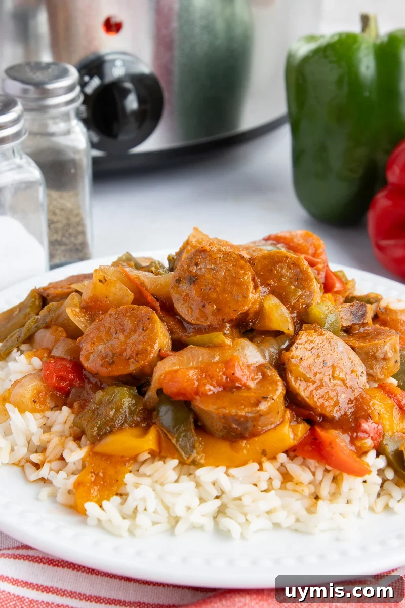 Crockpot Sausage and Peppers Recipe 4 Sausage and peppers served over a bed of rice.