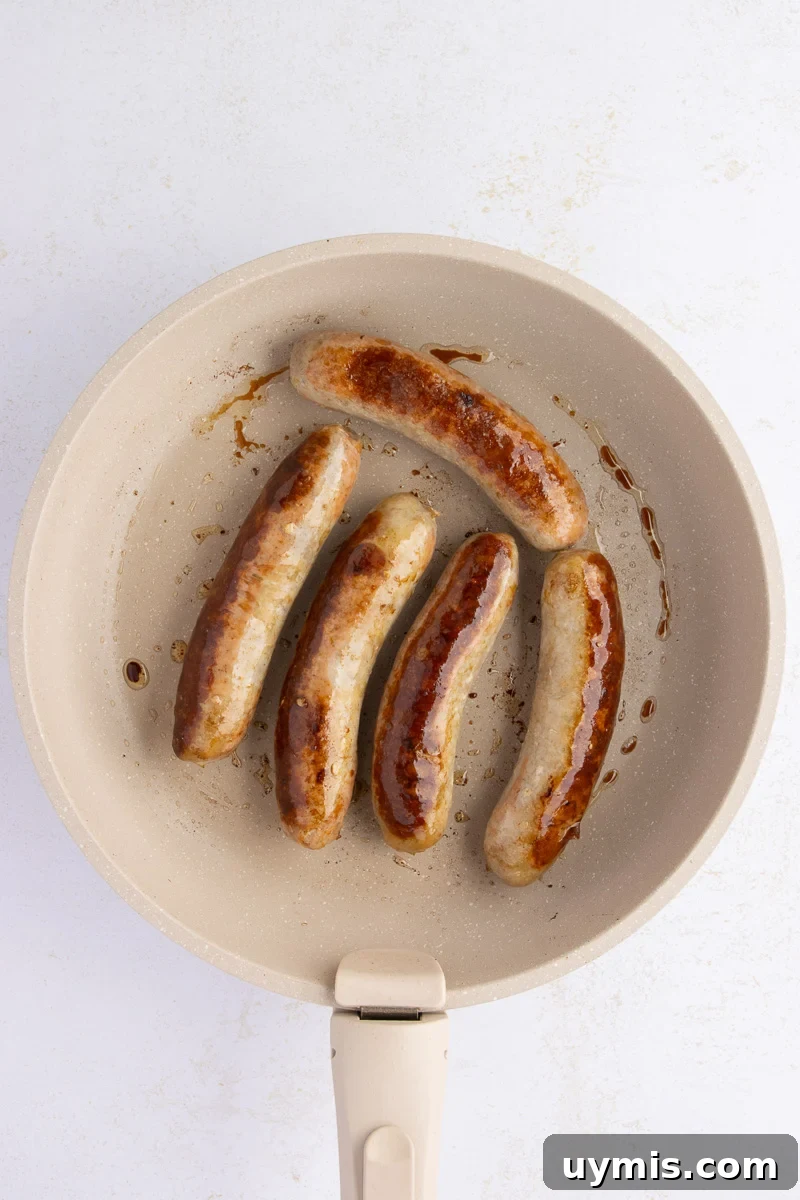 Crockpot Sausage and Peppers Recipe 8 Sausage being browned in skillet.