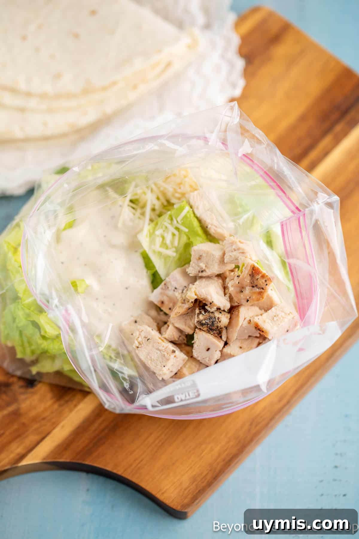 Chicken Caesar Wrap with Creamy Dressing 3 Salad ingredients in a zip top bag.