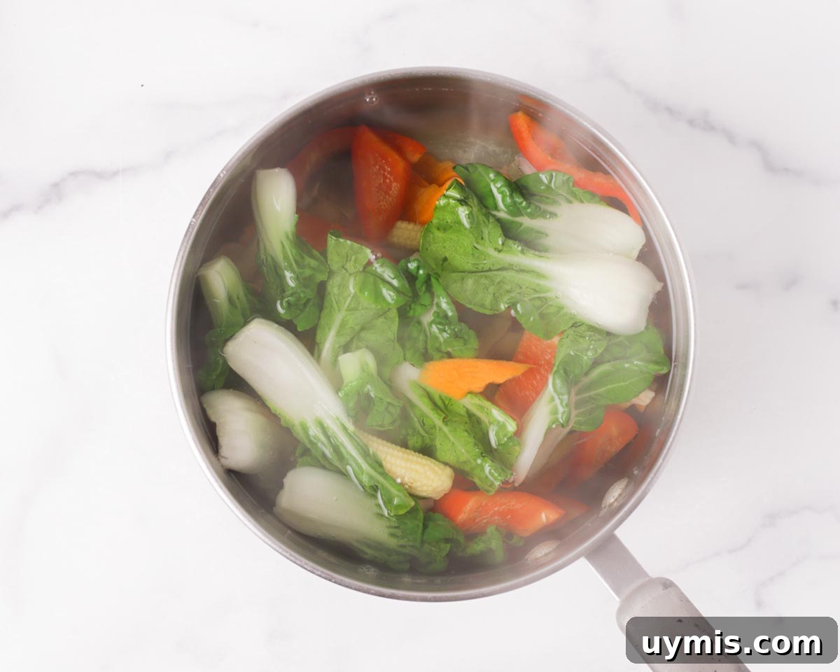 Vietnamese Crispy Noodle Stir Fry Mi Xao Gion 16 Blanching the vegetables in the water.