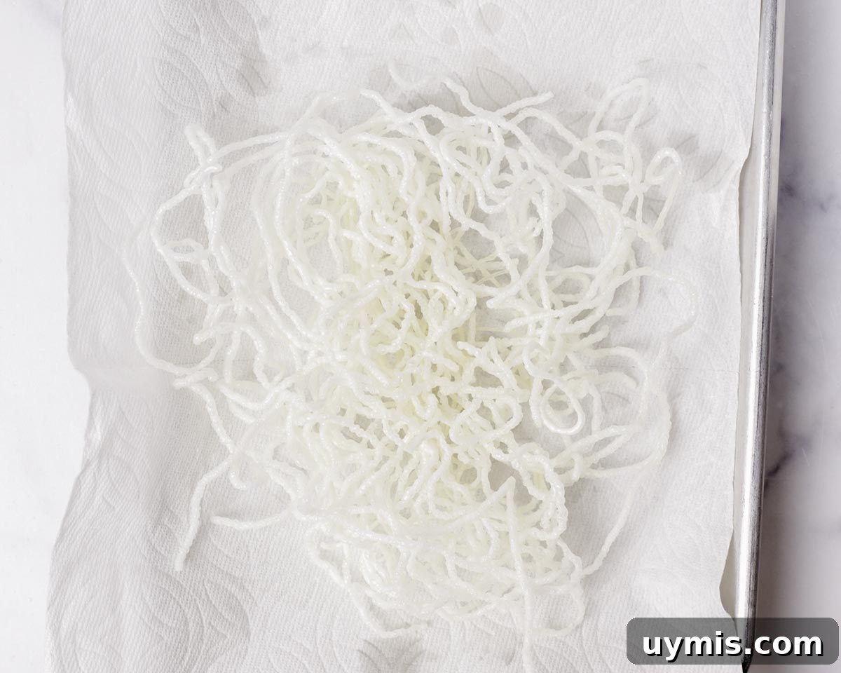 Vietnamese Crispy Noodle Stir Fry Mi Xao Gion 32 Fried rice vermicelli draining on paper towel.