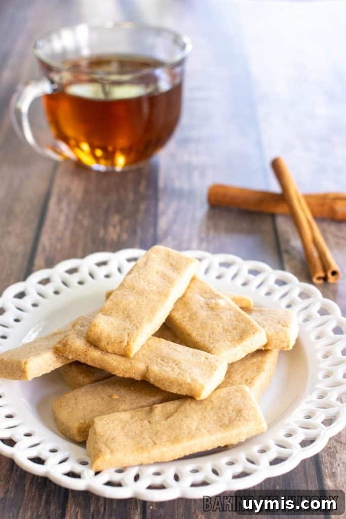 Cinnamon Shortbread Cookies Recipe 11 cinnamon shortbread cookies recipe on small decorative plate with tea behind