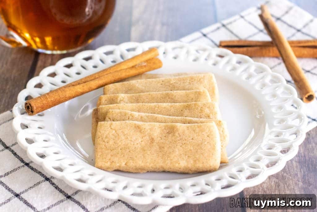 Cinnamon Shortbread Cookies Recipe 12 shortbread cookies on plate in a line