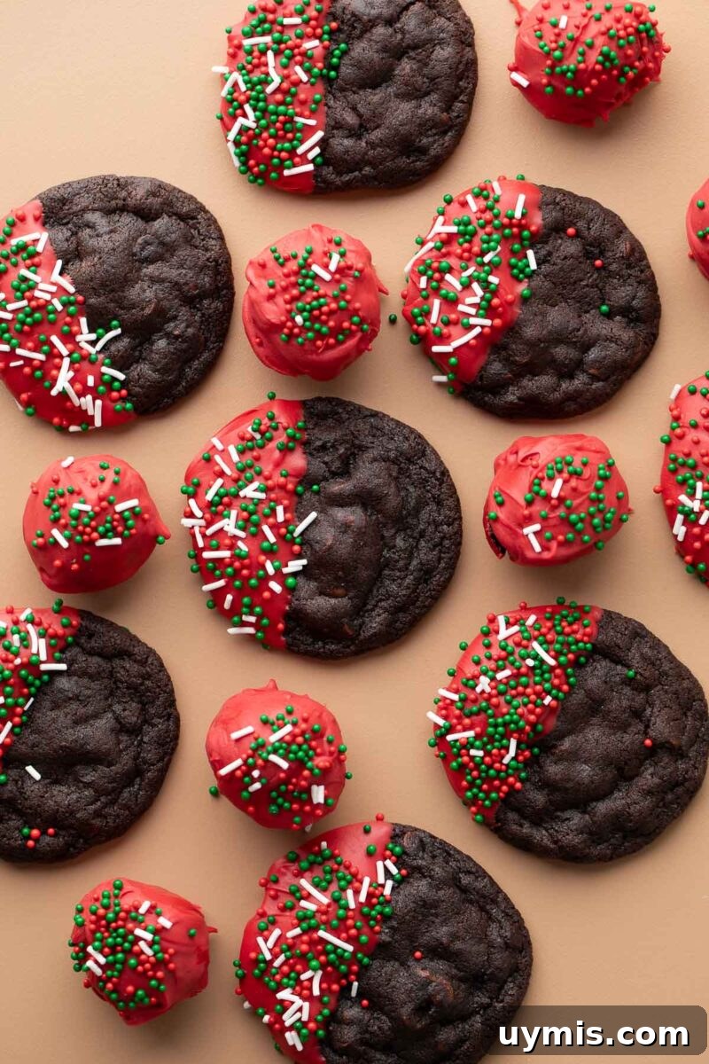 double chocolate Christmas cookies dipped in red candy melts and topped with holiday sprinkles