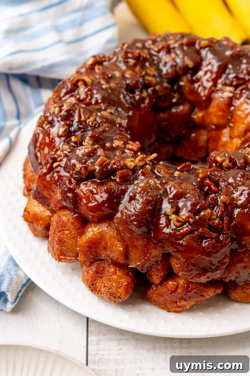 Warm Bananas Foster Monkey Bread with Rum-Caramel Glaze 4 A closeup of the complete Bananas Foster Monkey Bread on a white plate.
