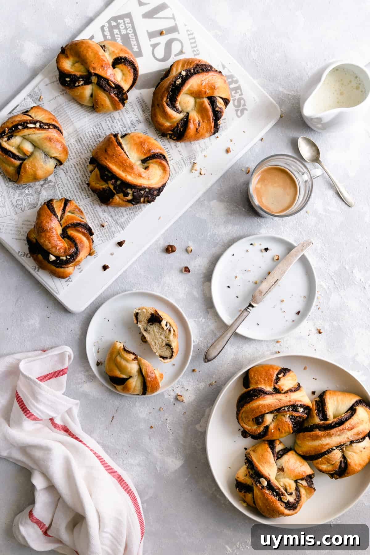 Overhead shot of chocolate hazelnut babka buns with small cup of coffee on side