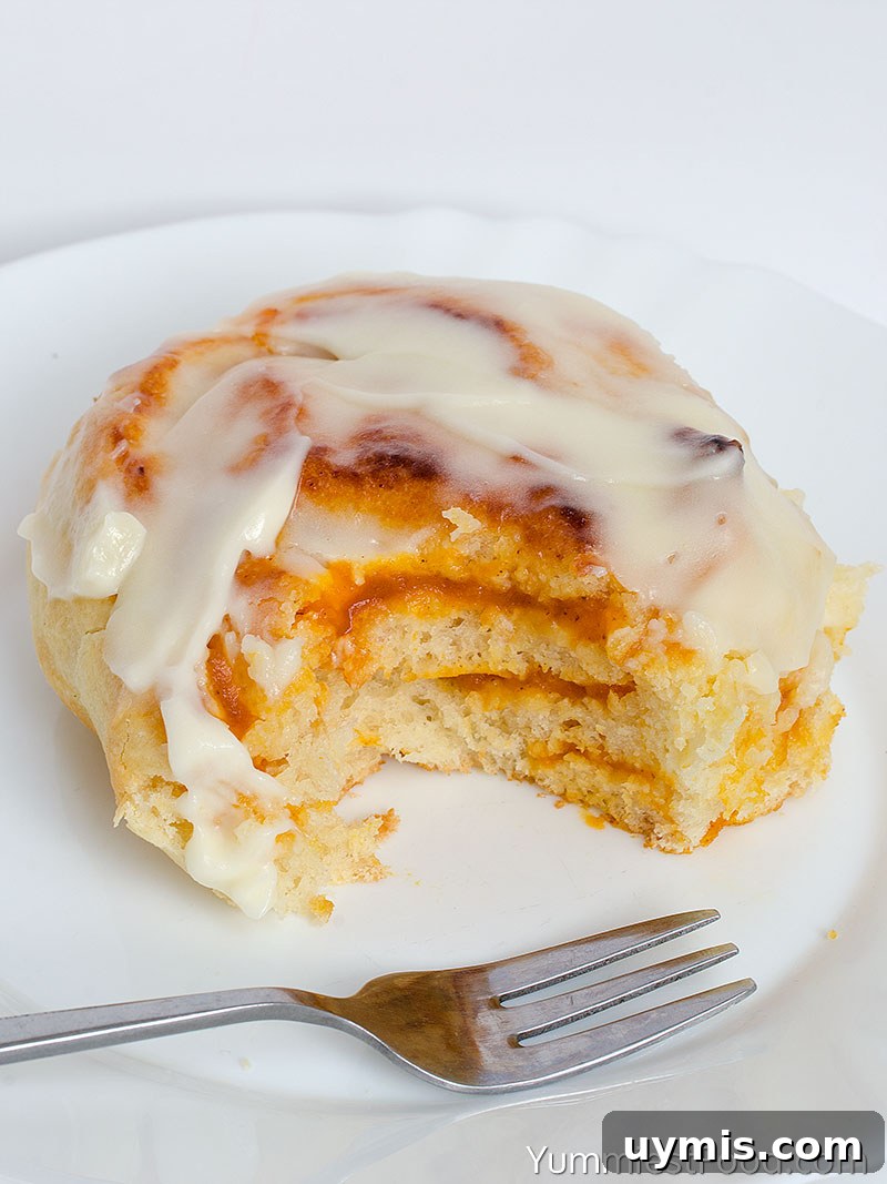 Pumpkin Cinnamon Rolls with Cream Cheese Frosting 6 Pumpkin Cinnamon Rolls With Cream Cheese Frosting - served on the plate