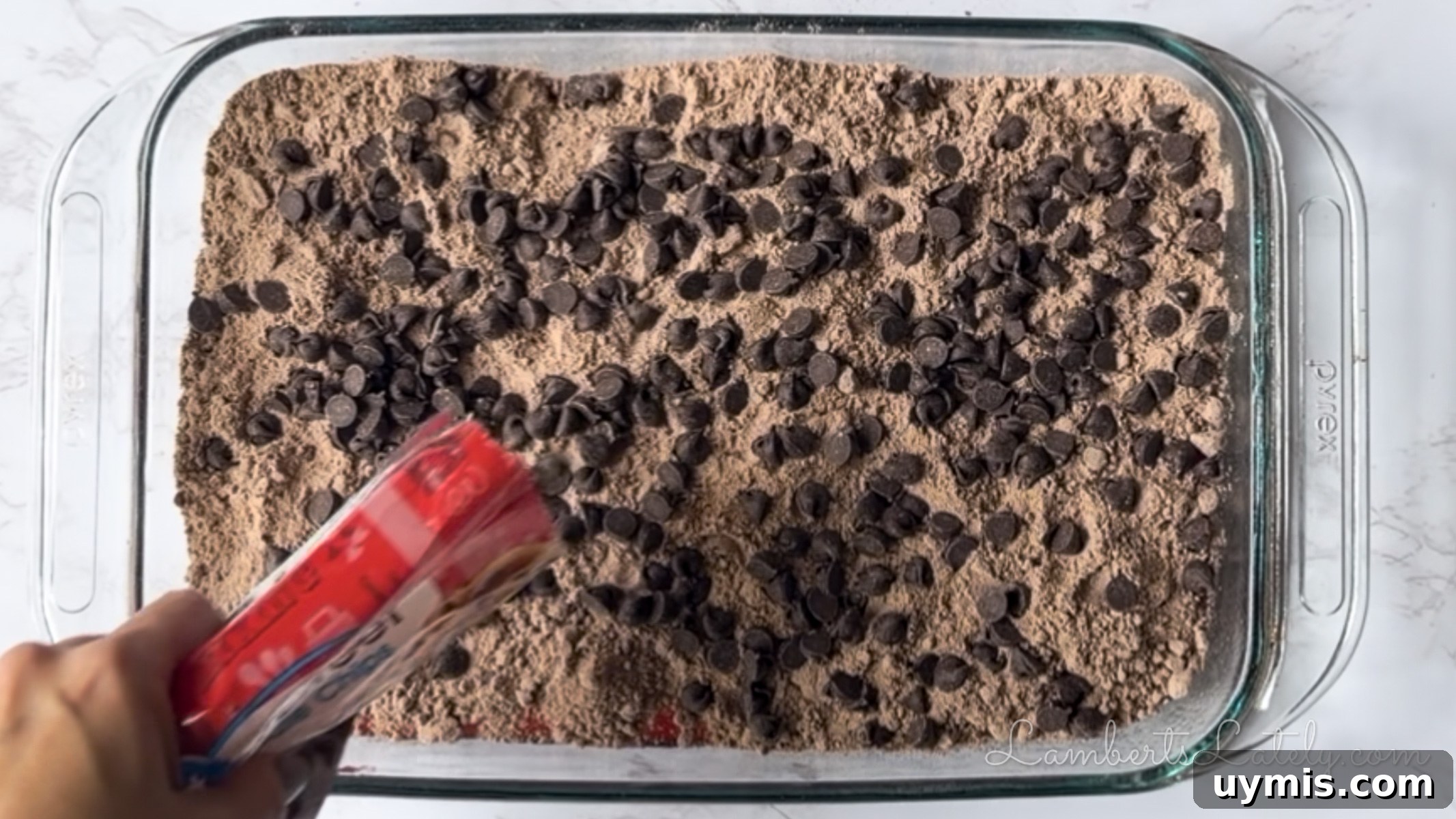 Chocolate Cherry Dump Cake Recipe 8 pouring chocolate chips over brownie mix.