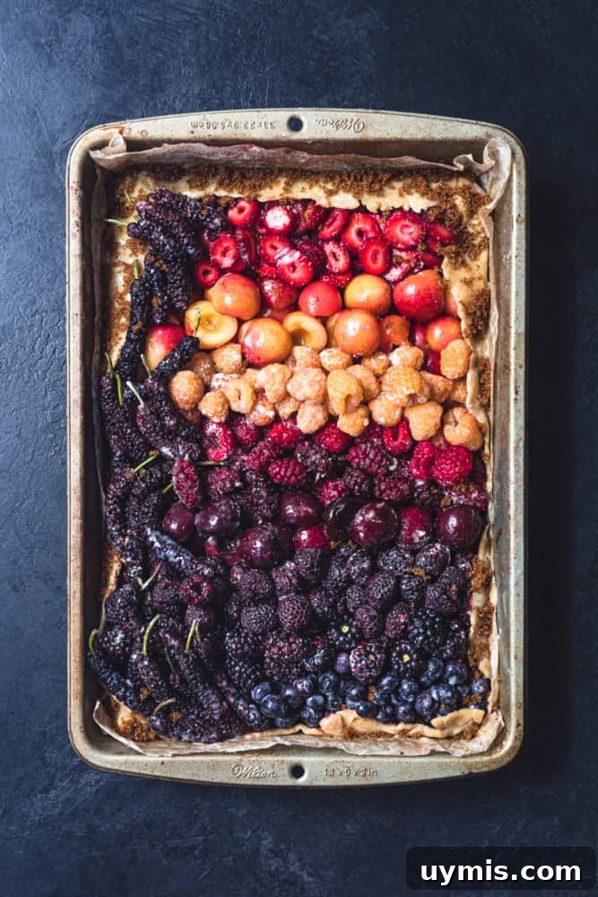 Summer Berry Galette with Fresh Seasonal Berries 2 Mixed berry galette before baking with colorful berries on buttery dough.