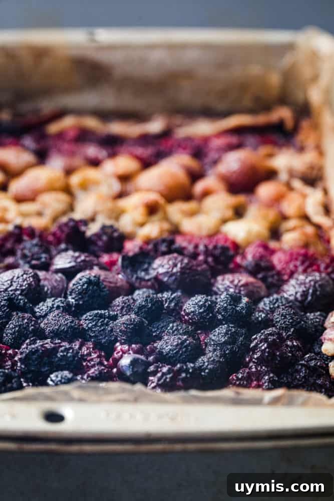 Summer Berry Galette with Fresh Seasonal Berries 12 Side view of baked mixed berry galette with purple raspberries, mulberries, and tayberries.