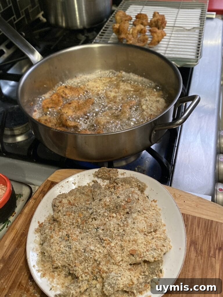 Italian Pan Fried Butterflied Shrimp Recipe 14 Frying the Italian Fried Shrimp in a large stainless steel pan.