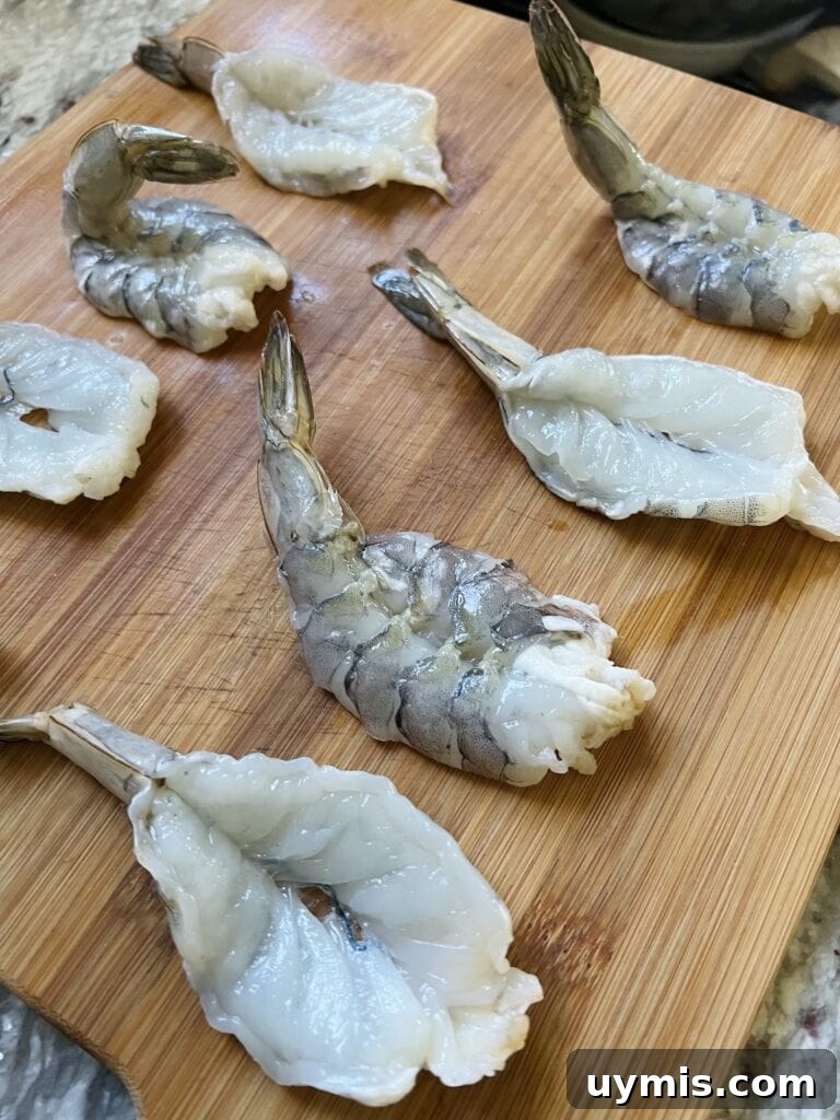 Italian Pan Fried Butterflied Shrimp Recipe 10 Several butterflied shrimp on cutting board ready to be breaded.