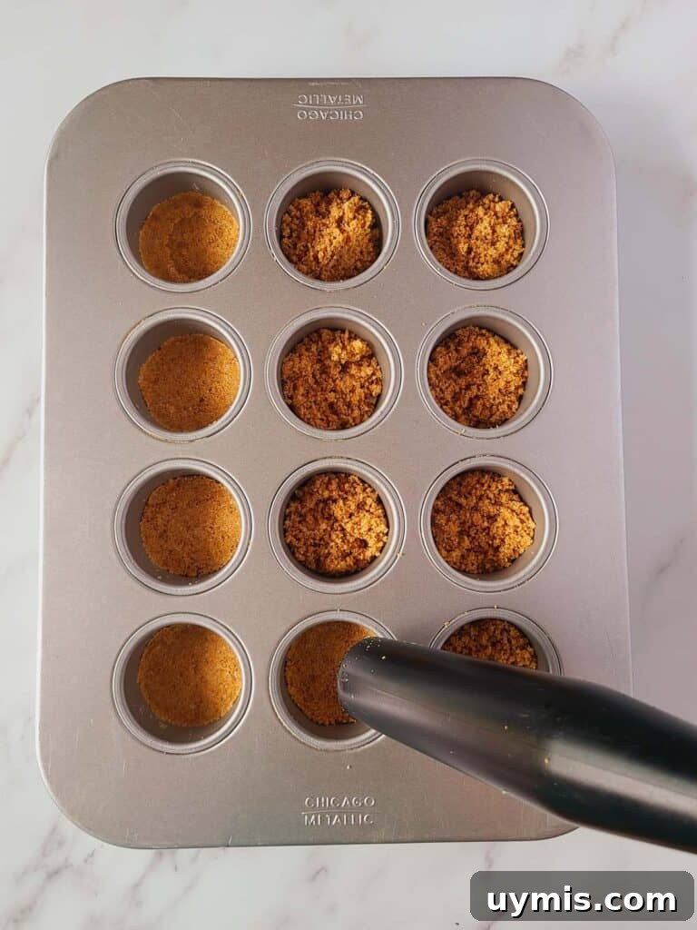 Mini Crème Brûlée Cheesecake Bites Recipe 11 Tapping with tamper on top of the graham cracker crust.