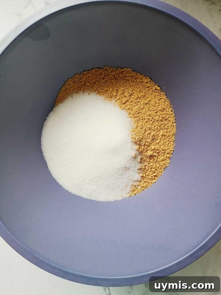 Mini Crème Brûlée Cheesecake Bites Recipe 6 In a blue bowl is sugar and graham cracker crumbs