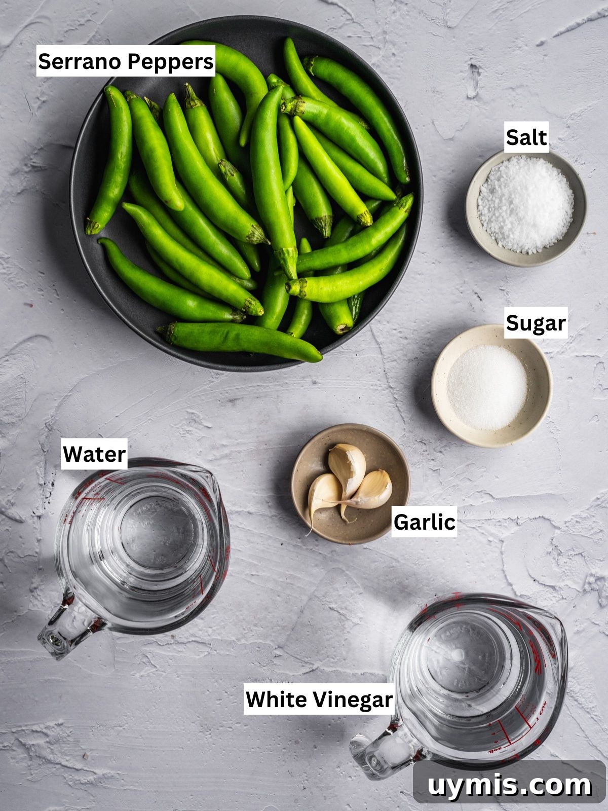 How to Make Pickled Serrano Peppers 3 Pickled Serrano Peppers recipe ingredients with individual labels on a board.
