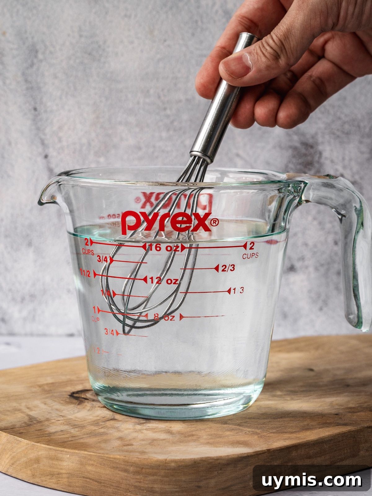 How to Make Pickled Serrano Peppers 4 Mixing a vinegar solution in a measuring cup.