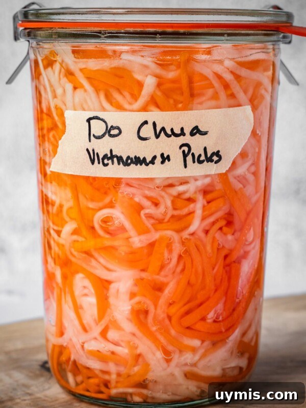 A sealed and labeled jar of do chua, Vietnamese pickled vegetables.