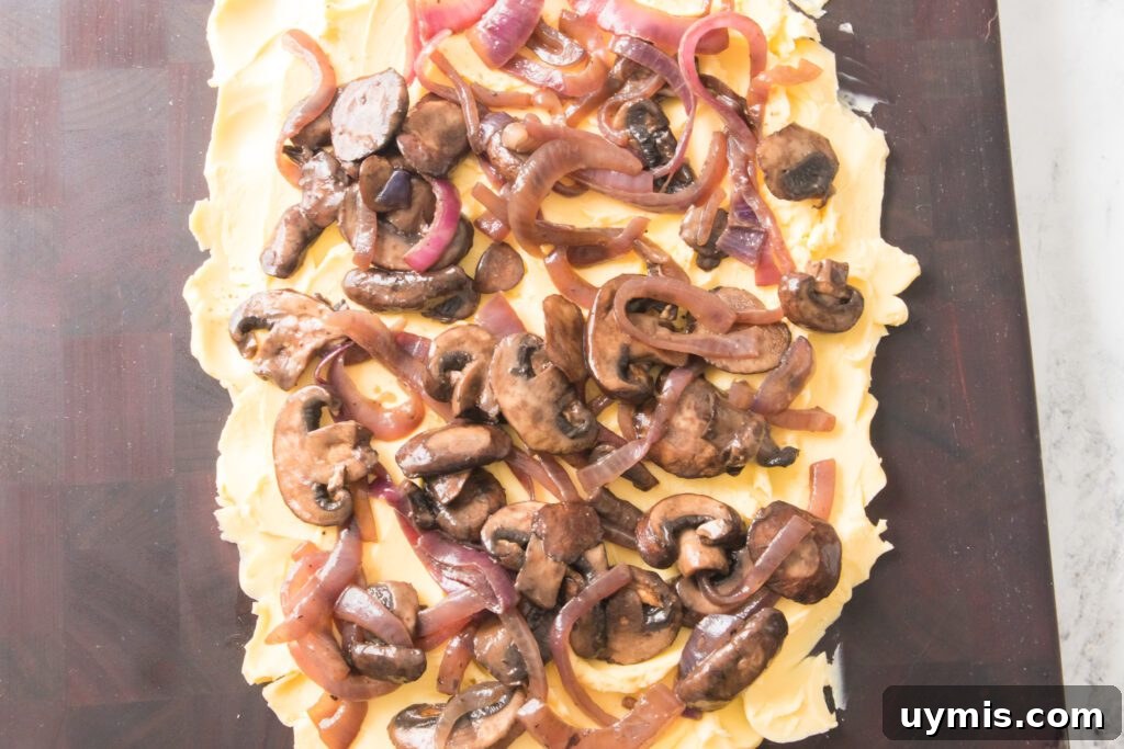cutting board with butter, onions and mushrooms