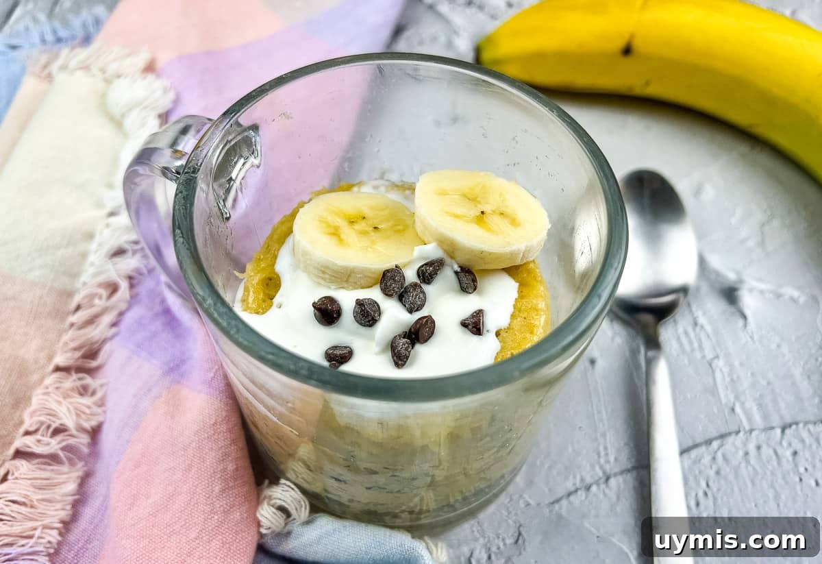 27 Chocolate Desserts You Can't Keep at Home 4 Banana chocolate mug cake with spoon and banana.