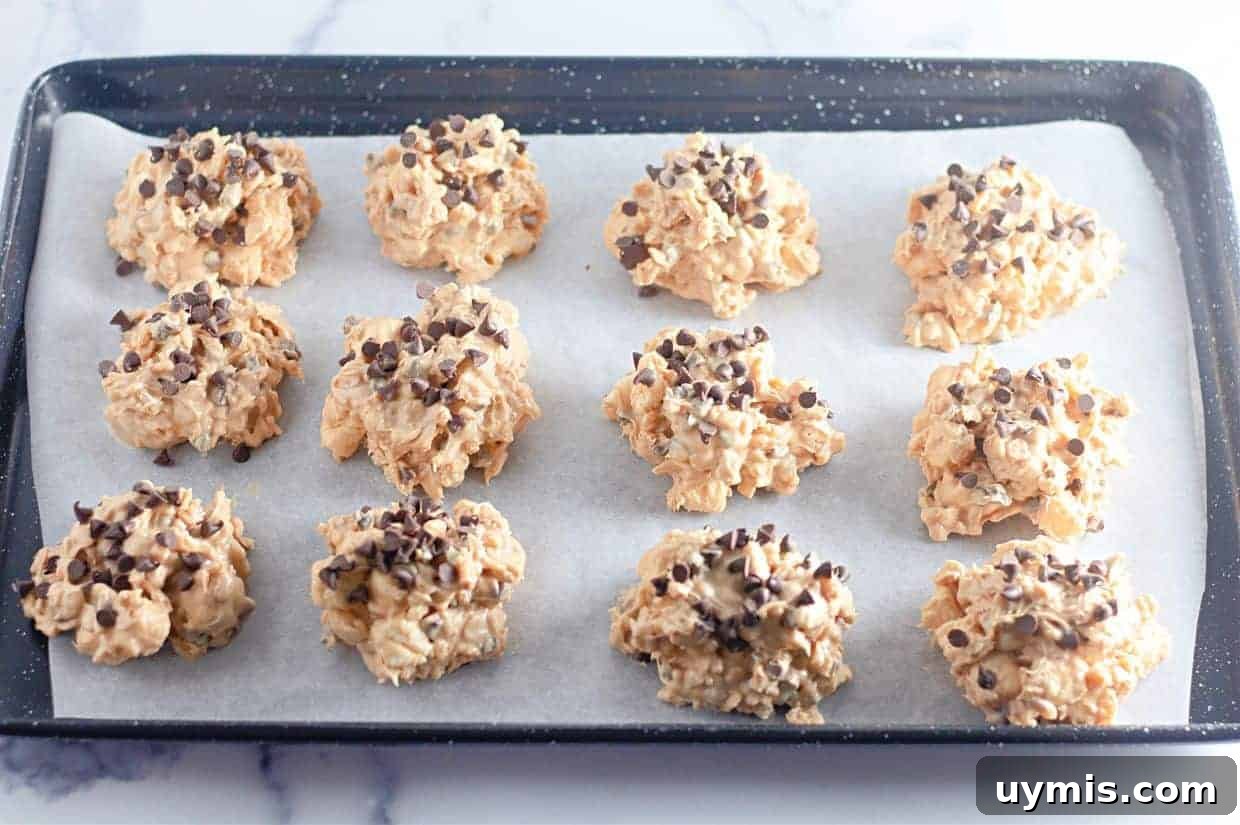 27 Chocolate Desserts You Can't Keep at Home 6 A baking tray lined with parchment paper holds twelve Avalanche Crunch Cookies.