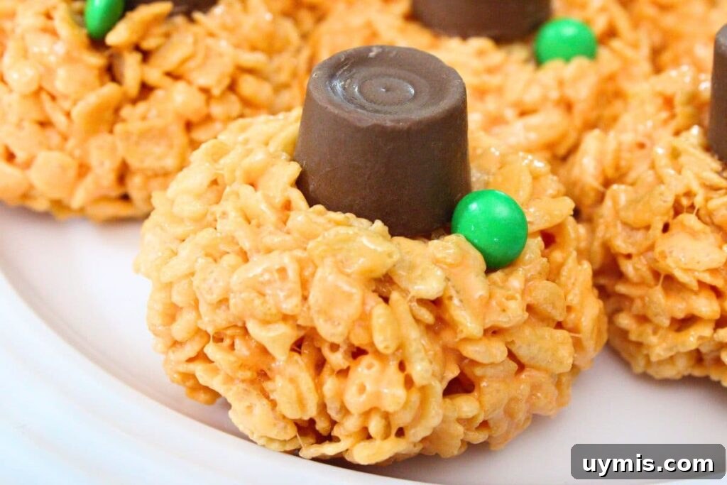 Fall Pumpkin Rice Krispie Treats with Rolos 18 closeup of halloween pumpkin rice krispie treat with a rolo on top