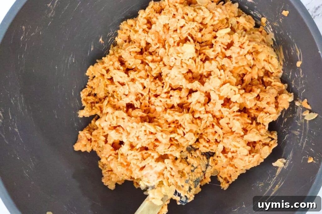 Fall Pumpkin Rice Krispie Treats with Rolos 8 add the rice krispie treats to the orange marshmallow mixture