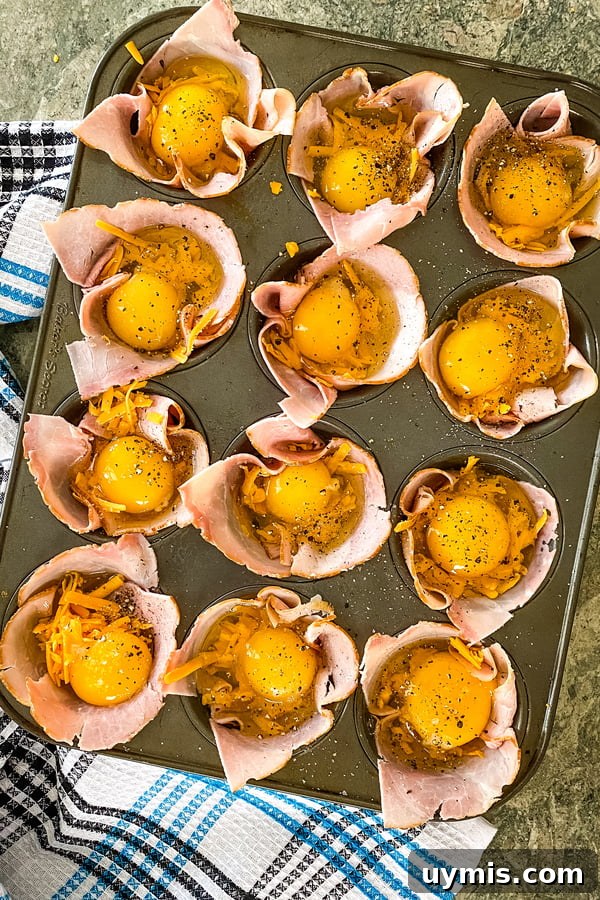 Make-Ahead Ham and Egg Breakfast Cups Recipe 4 ham and egg cups ready to go in the oven