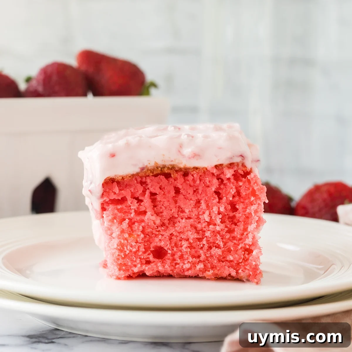 Moist Strawberry Sheet Cake with Cream Cheese Frosting 2 Slice of Strawberry Cake on 2 stacked white plates.