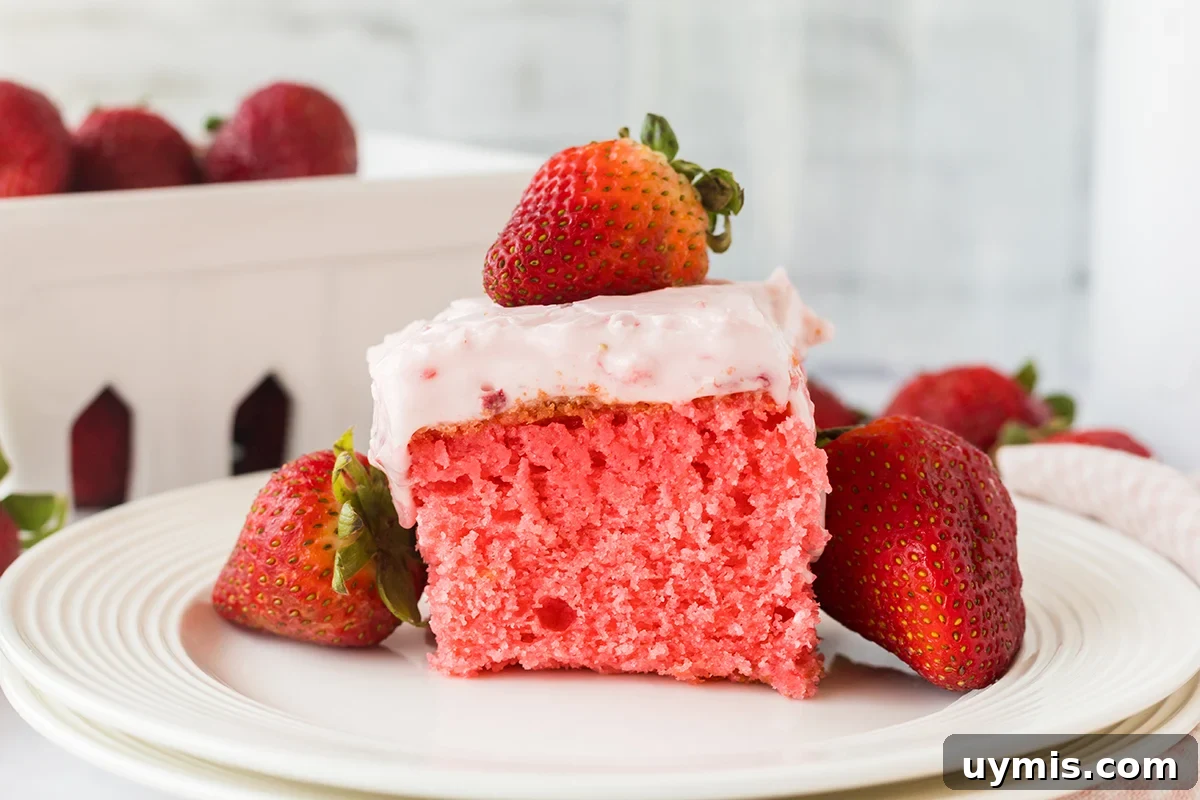 Moist Strawberry Sheet Cake with Cream Cheese Frosting 10 Strawberry Cake with cream cheese frosting topped with a strawberry.