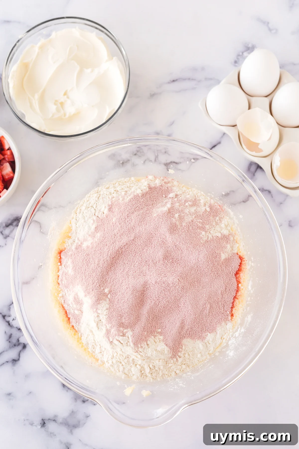 Moist Strawberry Sheet Cake with Cream Cheese Frosting 5 Jell-O powder, flour, baking powder and baking soda added to batter in mixing bowl.