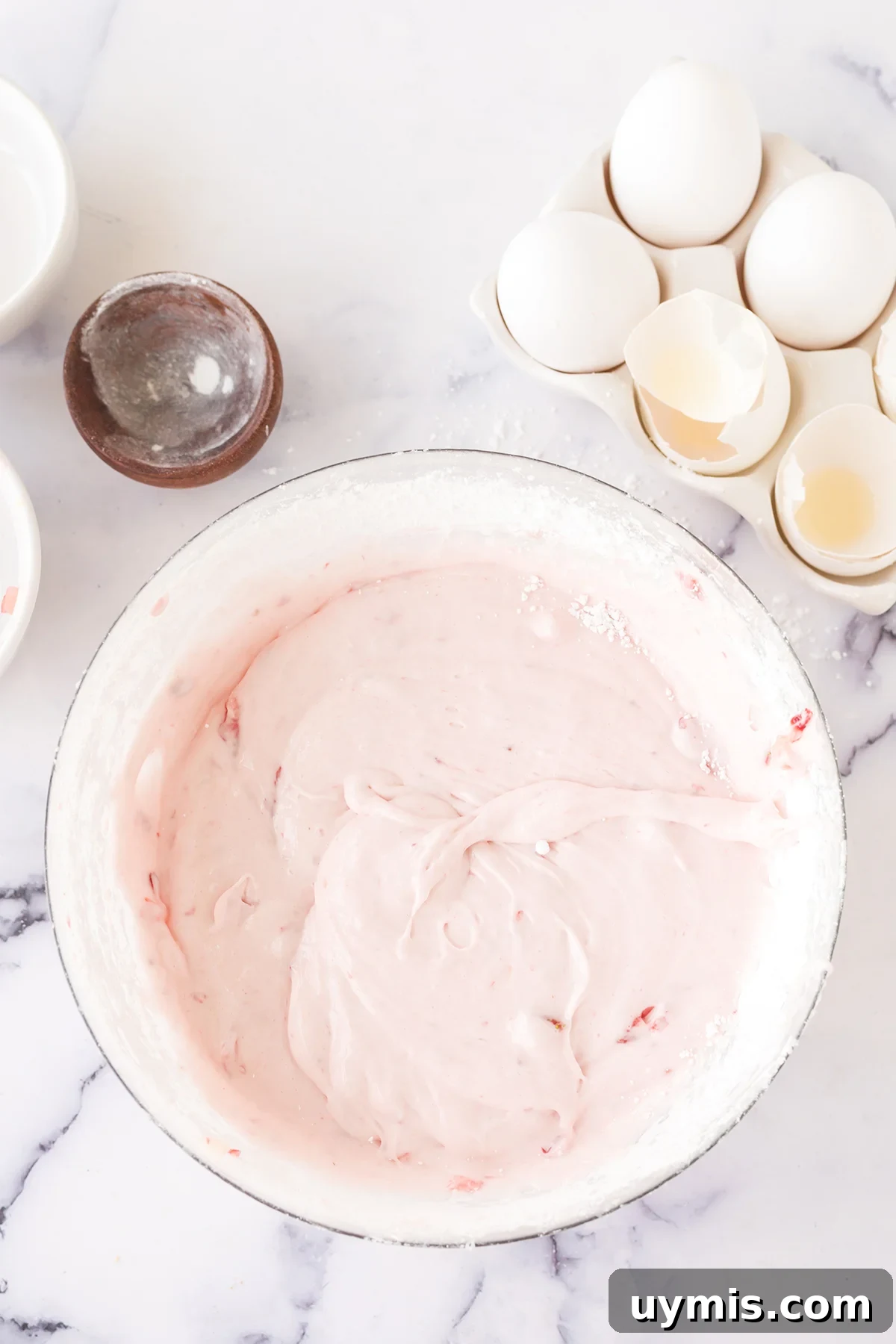 Moist Strawberry Sheet Cake with Cream Cheese Frosting 8 Strawberry cream cheese frosting in glass bowl.