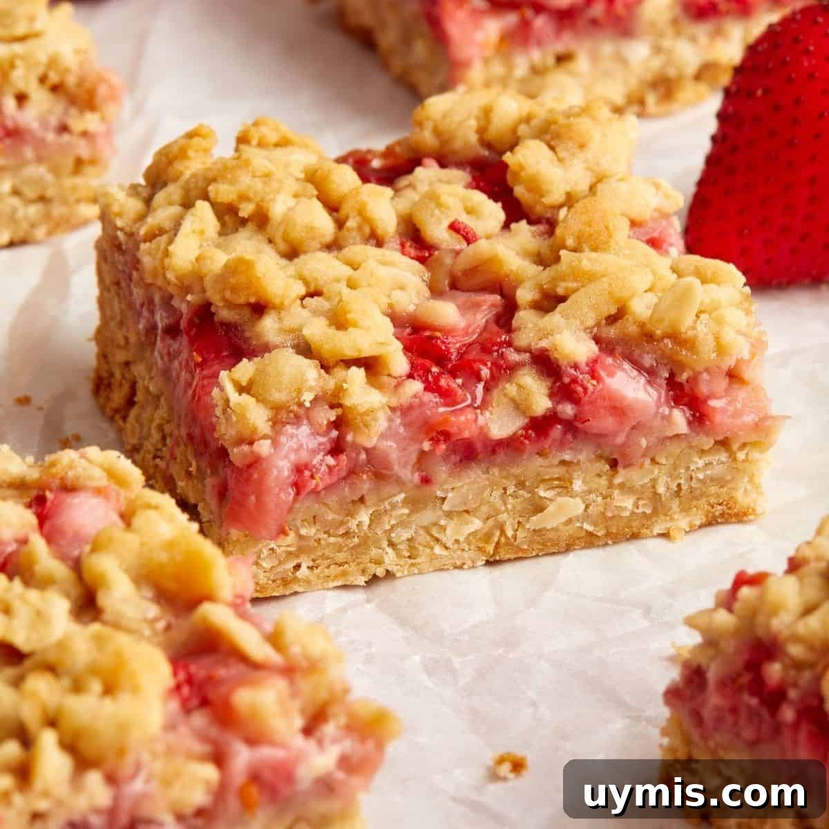Cut squares of Strawberry Oatmeal Bars on some baking paper.
