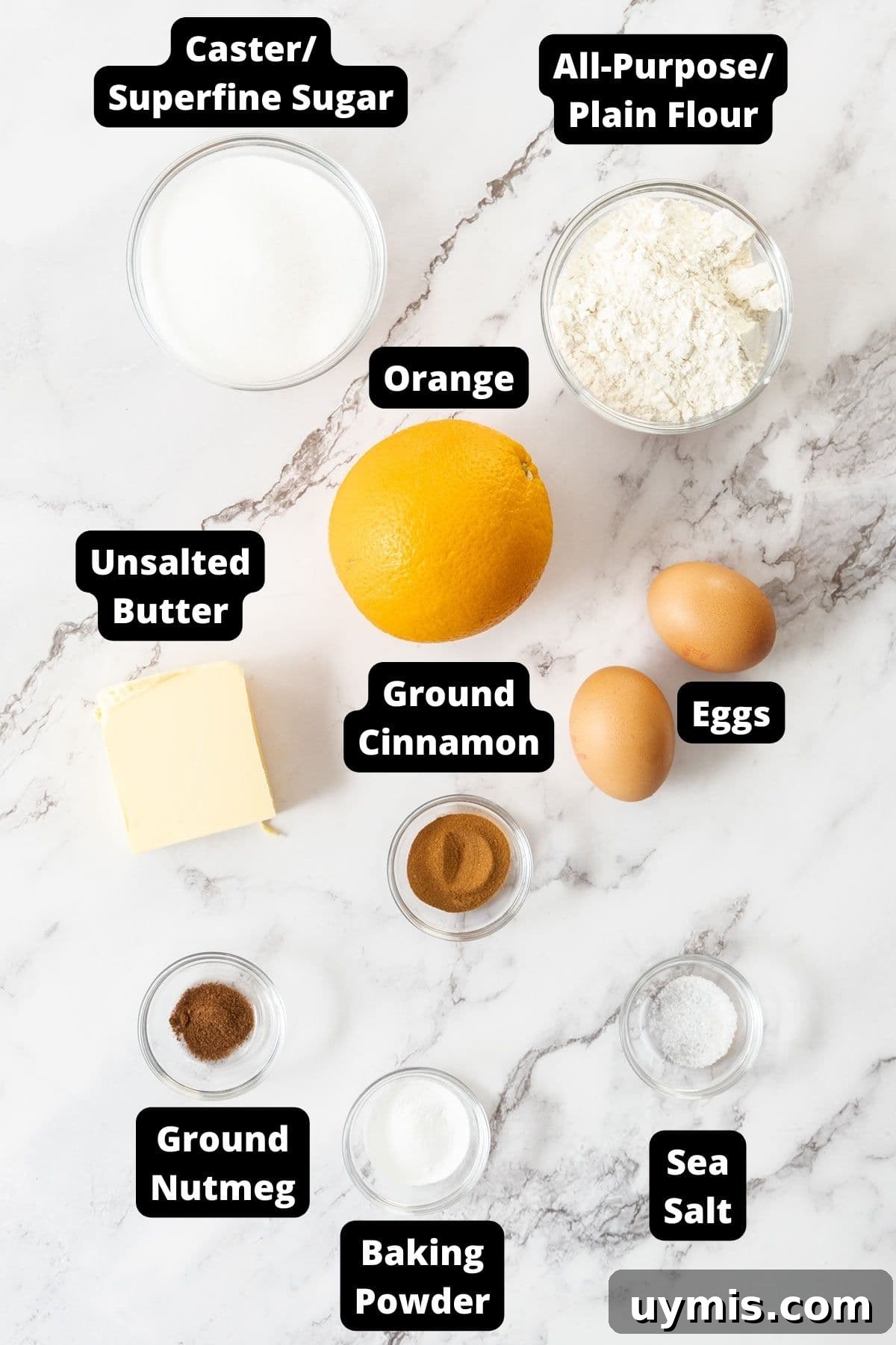 Spiced Orange Madeleines Recipe 3 Ingredients in this recipe on a white marble background.