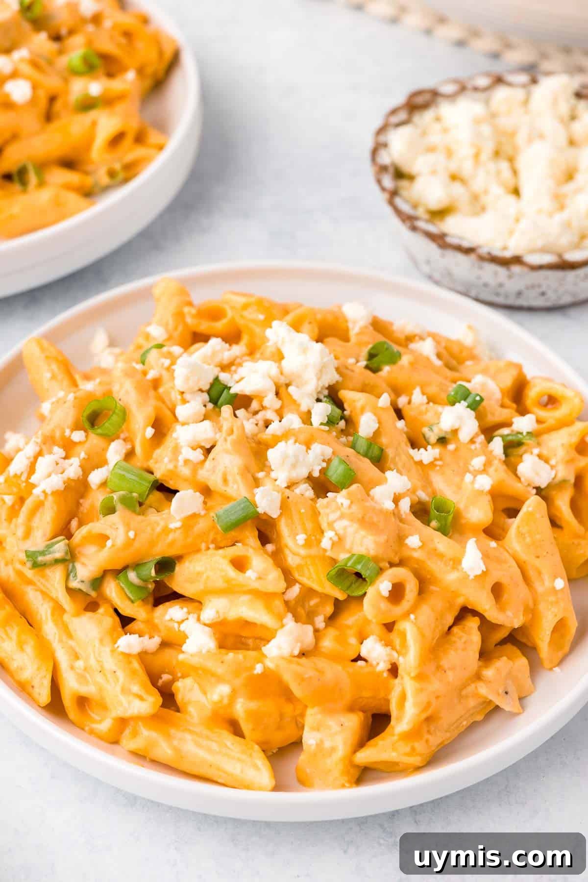 Buffalo Chicken Pasta topped with feta cheese crumbles
