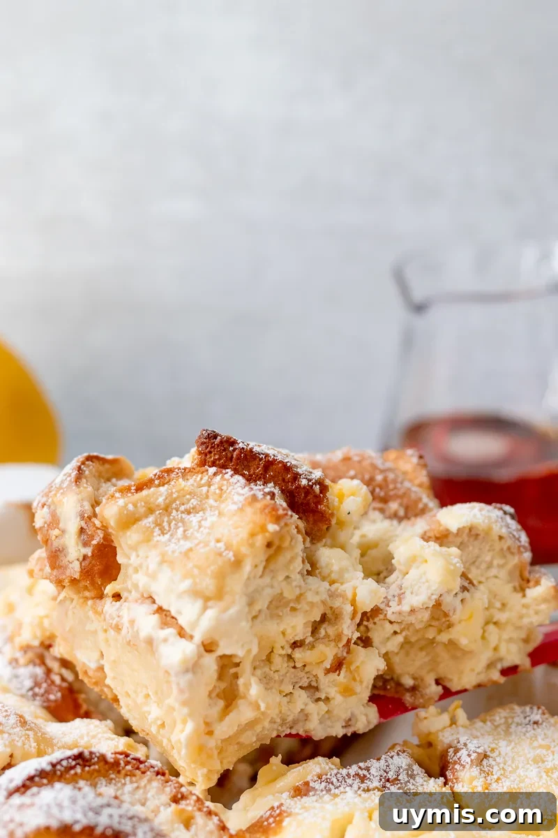 Lemon Cheesecake French Toast Casserole Recipe 4 single serving of cheesecake french toast being lifted from casserole