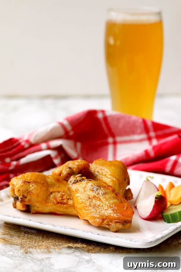 Bacon Wrapped Dates Stuffed with Blue Cheese and Almonds 8 Hot wings on a plate