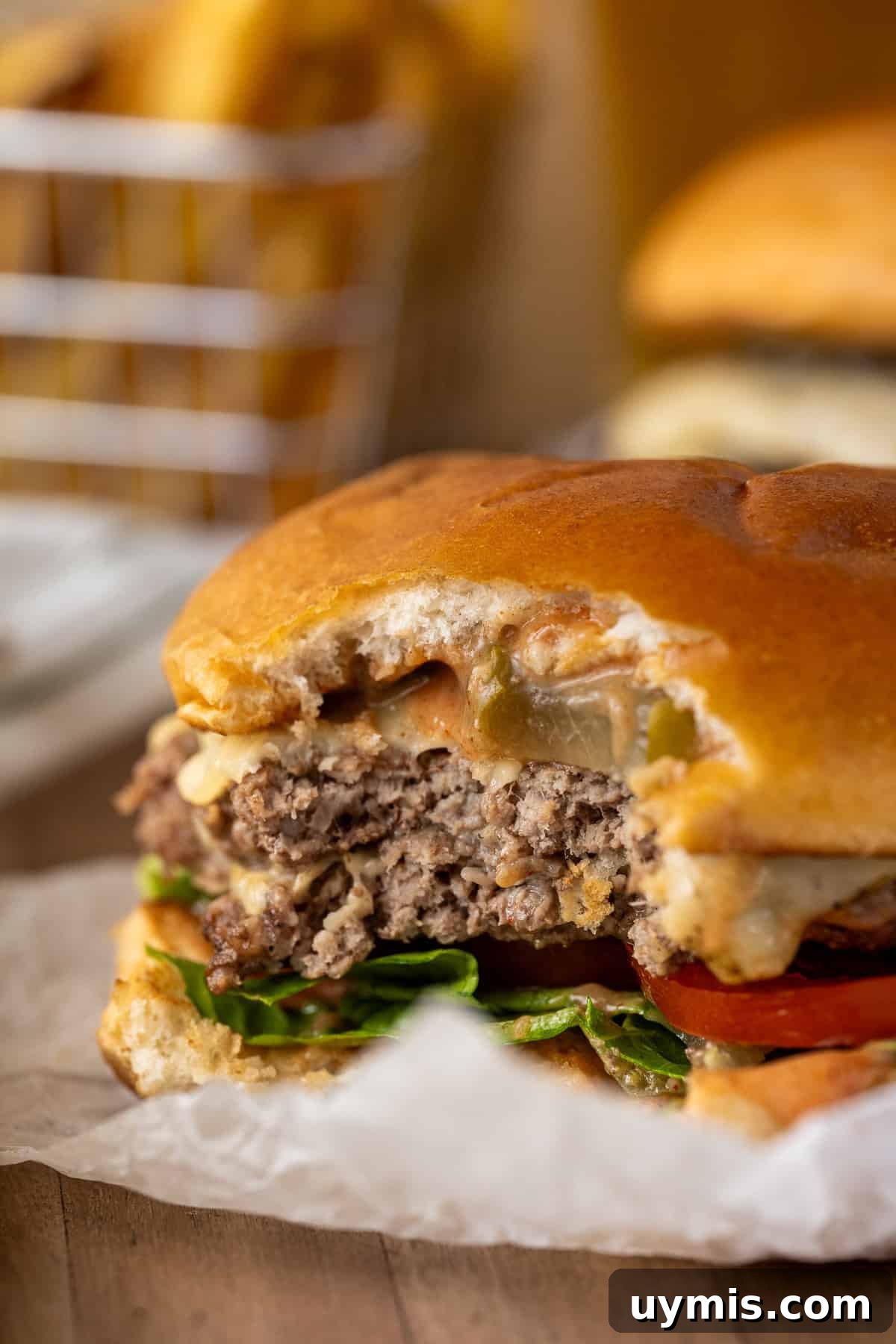 Smash Burger Recipe with Crispy Edges 13 A close up of a smash burger with a bite taken.