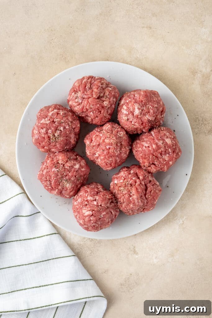 Smash Burger Recipe with Crispy Edges 7 Balls of mince on a plate.