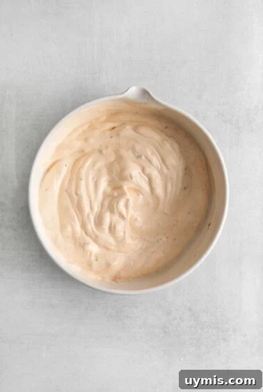 A bowl of creamy seasoned sour cream.