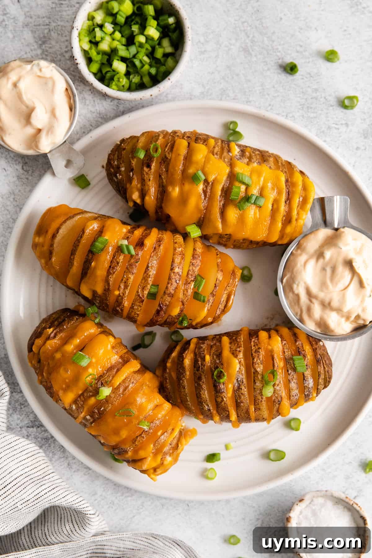 Hasselback potatoes on a plate.